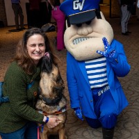 Lady and her dog pose with Louie the Laker